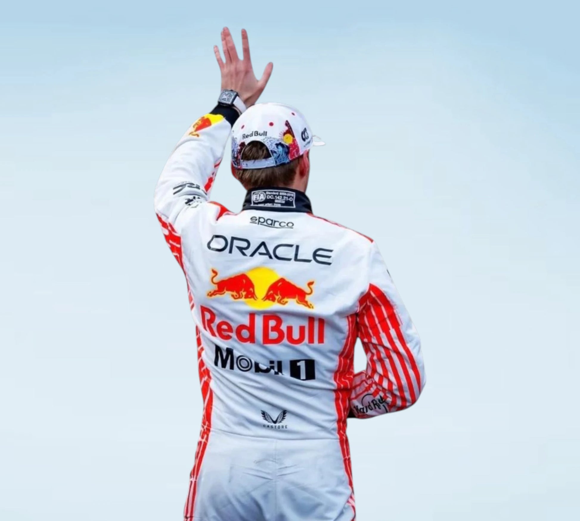 A Red Bull Racing driver seen from behind, wearing a white racing suit with red stripes and sponsor logos, including Oracle, Red Bull, Mobil 1, and Sparco, while waving with one hand against a pale sky.