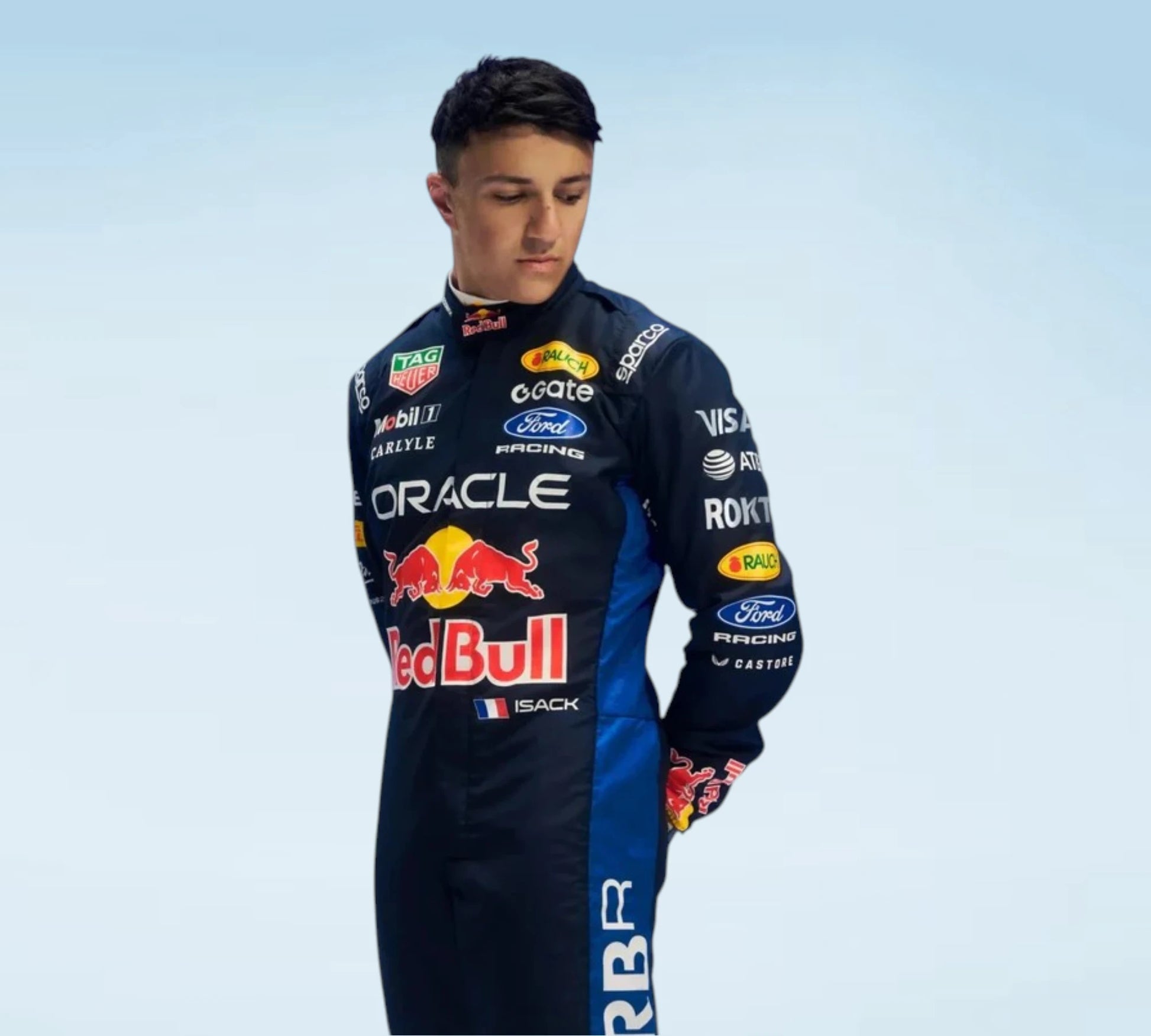 A man wearing a dark blue Oracle Red Bull Racing team racing suit with various sponsor logos, including Red Bull, Ford, and Castore, posed against a light blue gradient background.