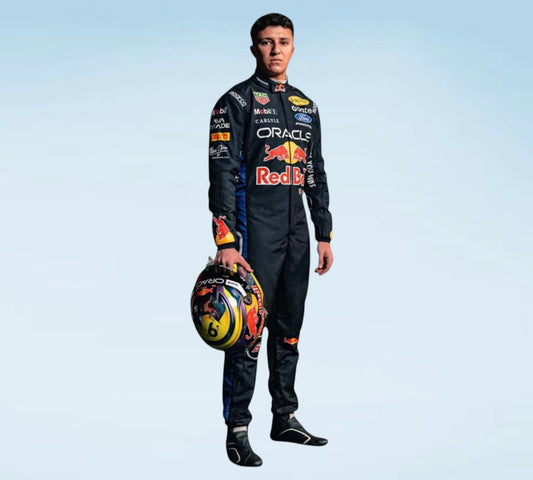 A man stands against a light blue gradient background wearing a full Red Bull Racing suit and holding a Red Bull helmet. The suit is black with prominent red, yellow, and white sponsor logos, including Oracle, Red Bull, and Castore.