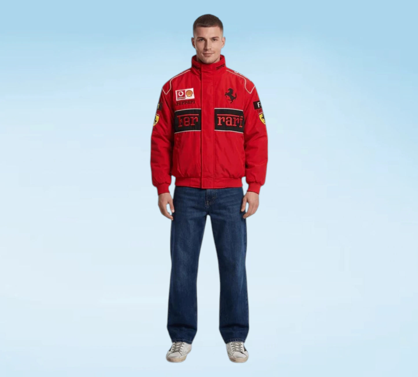 Man wearing a red Ferrari jacket and blue jeans on a light blue background