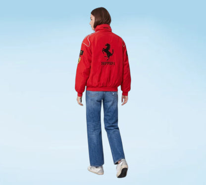 Person wearing a red jacket with a logo on a light blue background