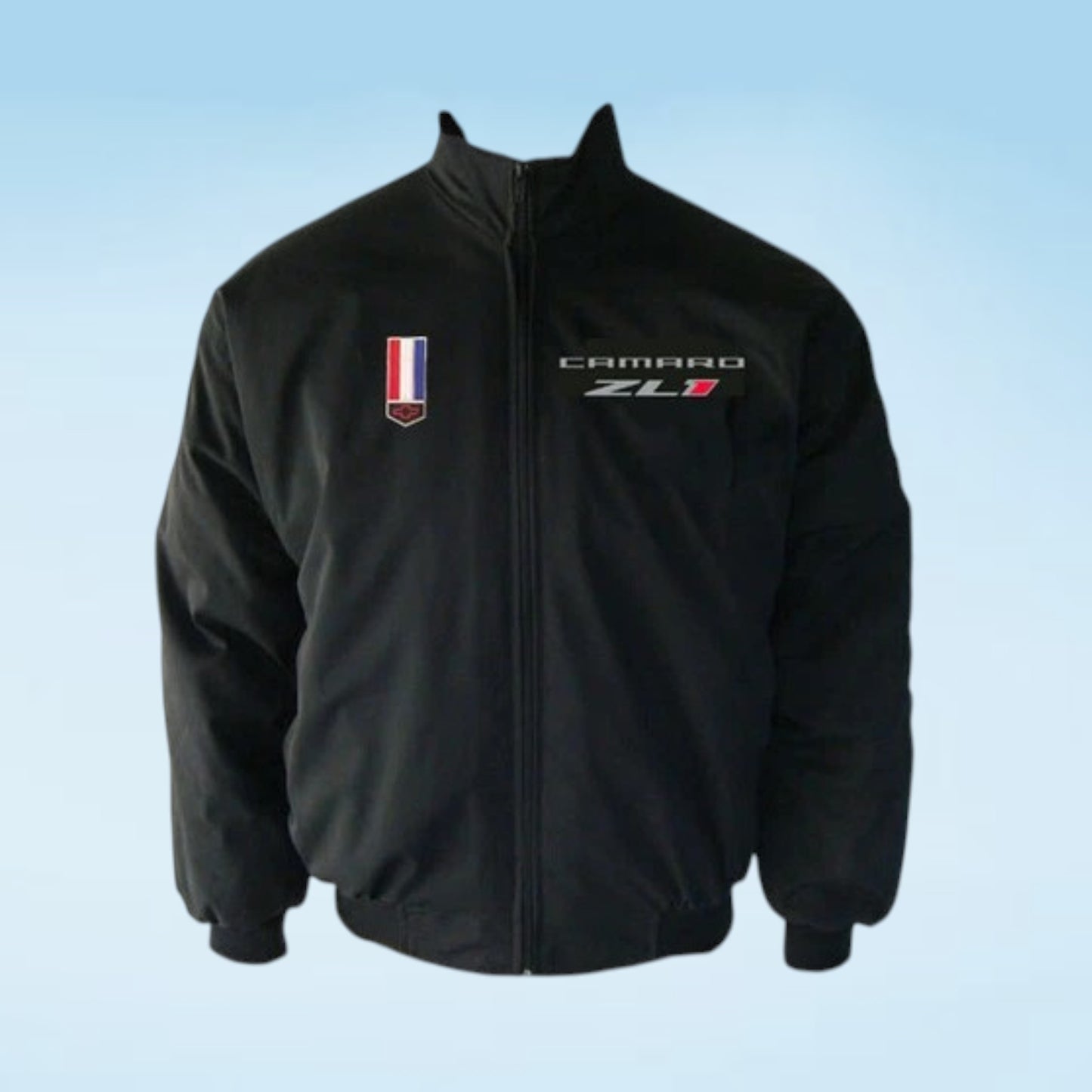 A black zip-up jacket featuring a 'CAMARO ZL1' embroidered logo on the left chest and a small vertical tricolor flag patch on the right chest, displayed against a light blue gradient background.