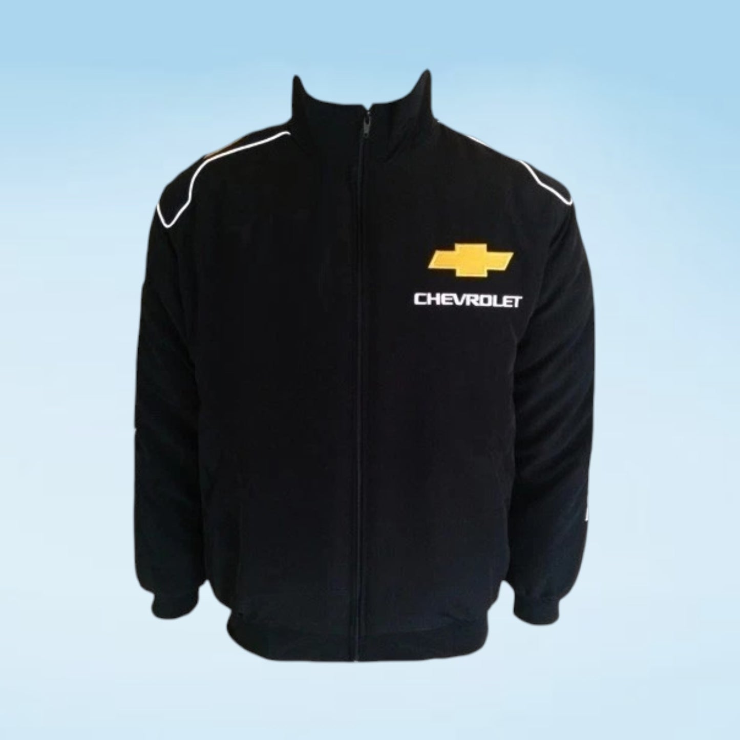 A black zip-up track jacket featuring a yellow Chevrolet bowtie logo and white 'CHEVROLET' text on the left chest, with white piping on the shoulders, shown against a light blue gradient background.