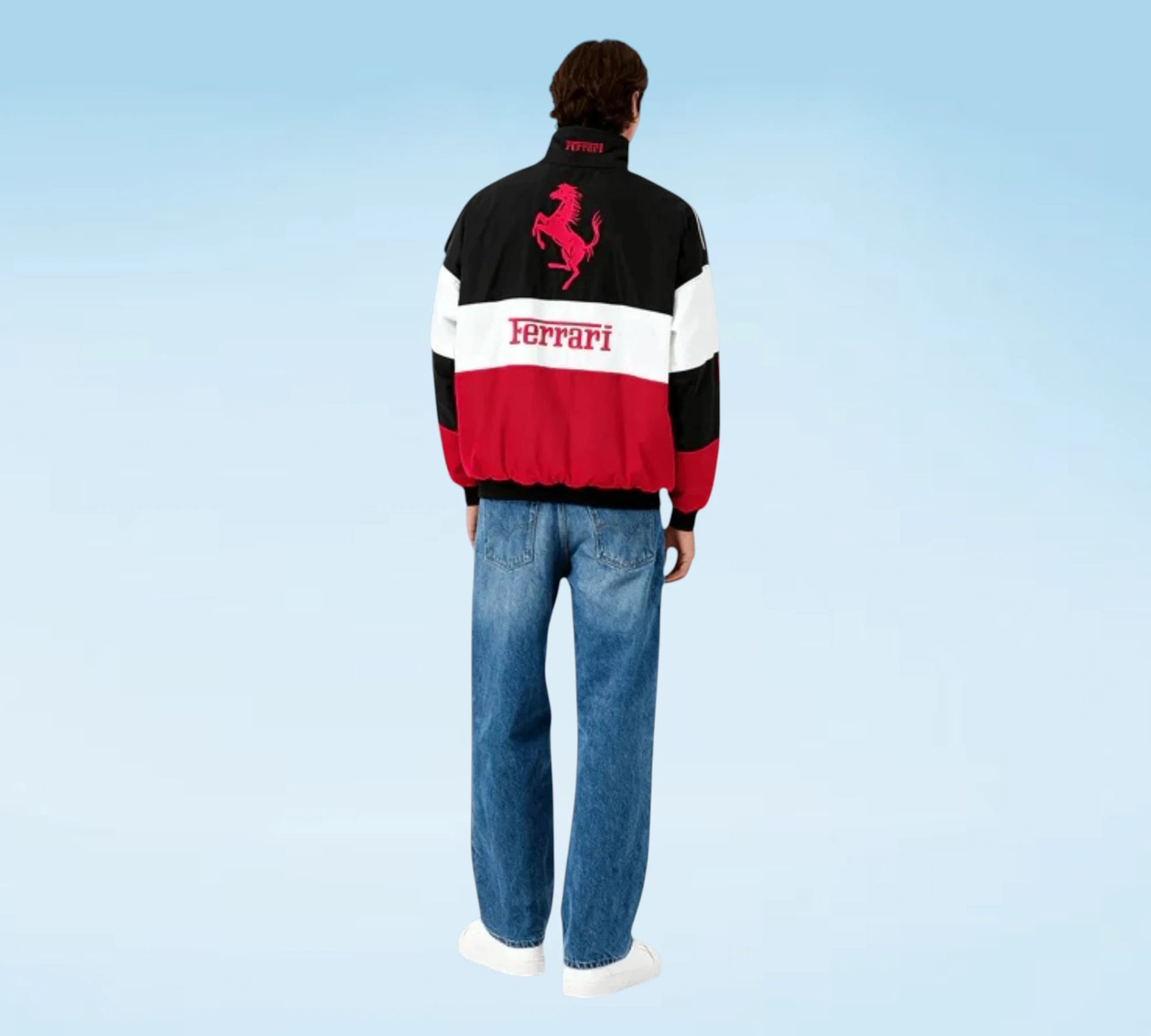 Person wearing a Ferrari jacket with a blue background