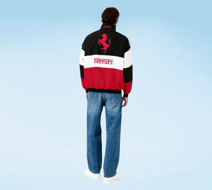 Person wearing a Ferrari jacket with a blue background