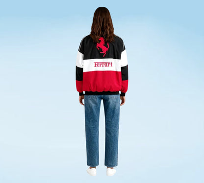 Person wearing a Ferrari-themed jacket with a blue background