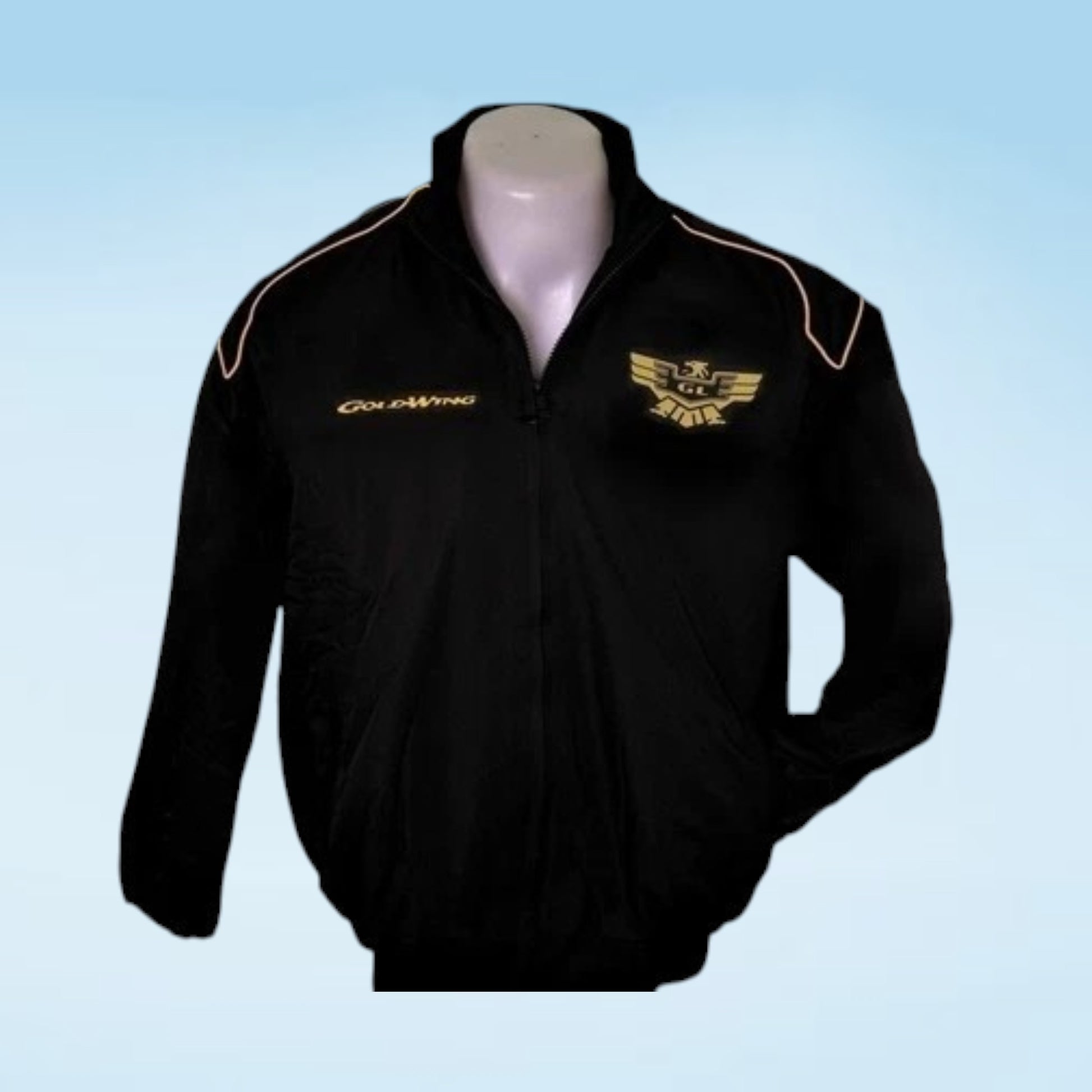 A black zip-up athletic jacket displayed on a mannequin torso against a light blue gradient background. The jacket features gold embroidered text reading 'Gio Almoa' on the right chest and a gold winged crest on the left chest, with thin gold piping along the shoulders.