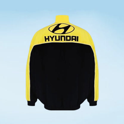 A Hyundai track jacket shown from the back, featuring a bright yellow upper back, shoulders, and sleeves with a black body and black Hyundai logo.