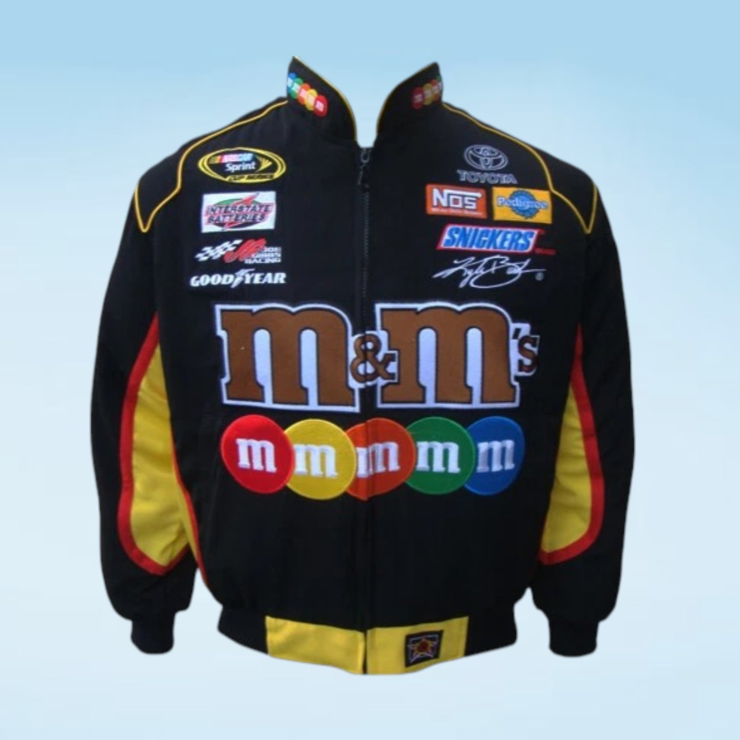 A black zip-up racing-style jacket with large M&M's branding across the front, plus sponsor logos including Goodyear, NOS, and Snickers, shown on a light blue gradient background.