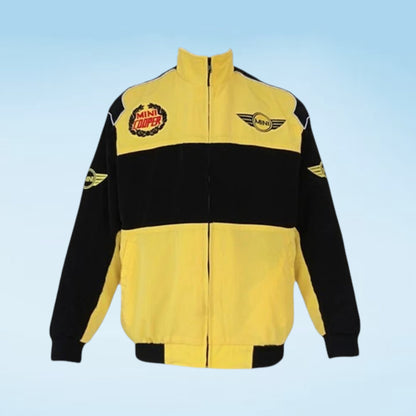 A yellow and black zip-up jacket featuring a high collar, a wide black chest stripe, and racing-style graphics including a circular 'Animal Tracks' patch and a winged 'MotoGP' logo on the chest.