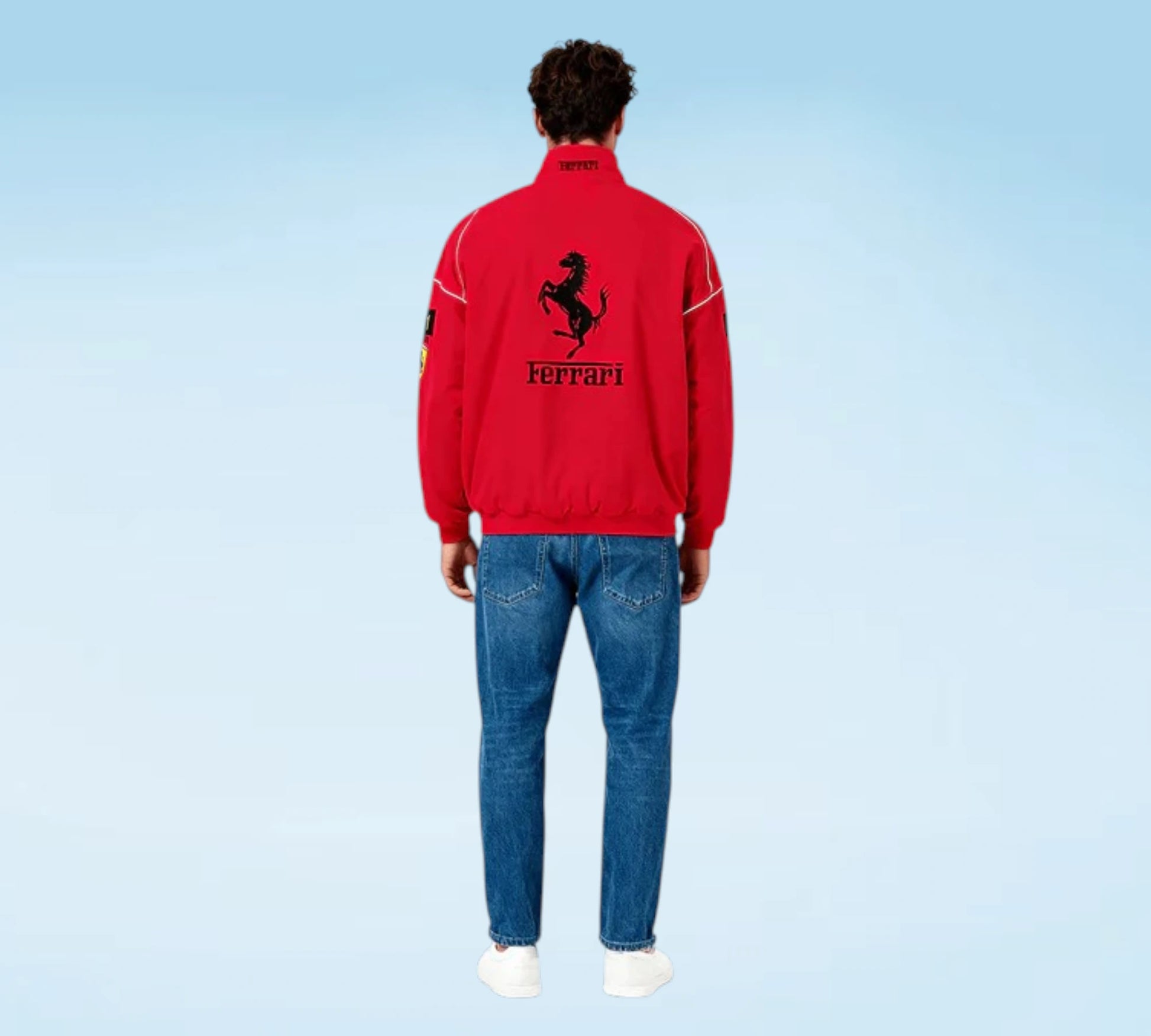 Person wearing a red Ferrari jacket and blue jeans on a light blue background
