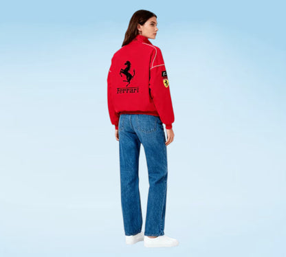 Person wearing a red Ferrari jacket with a blue background