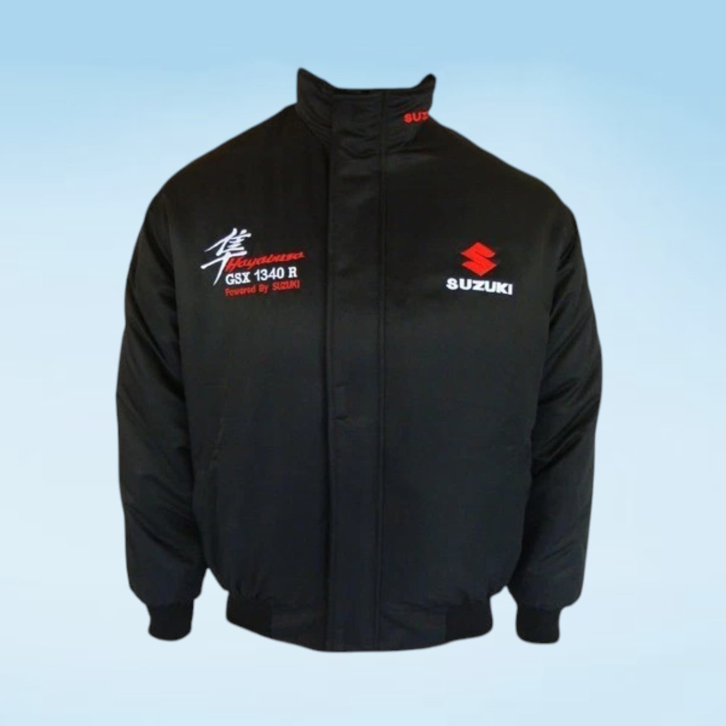 A black Suzuki GSX 1340 R jacket with red and white embroidered logos on the chest, displayed against a light blue gradient background.