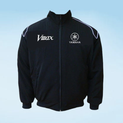 A black zip-up track jacket featuring white embroidered logos for 'Vimax' and 'Yamaha' on the chest, with white piping along the shoulders, shown against a light blue gradient background.